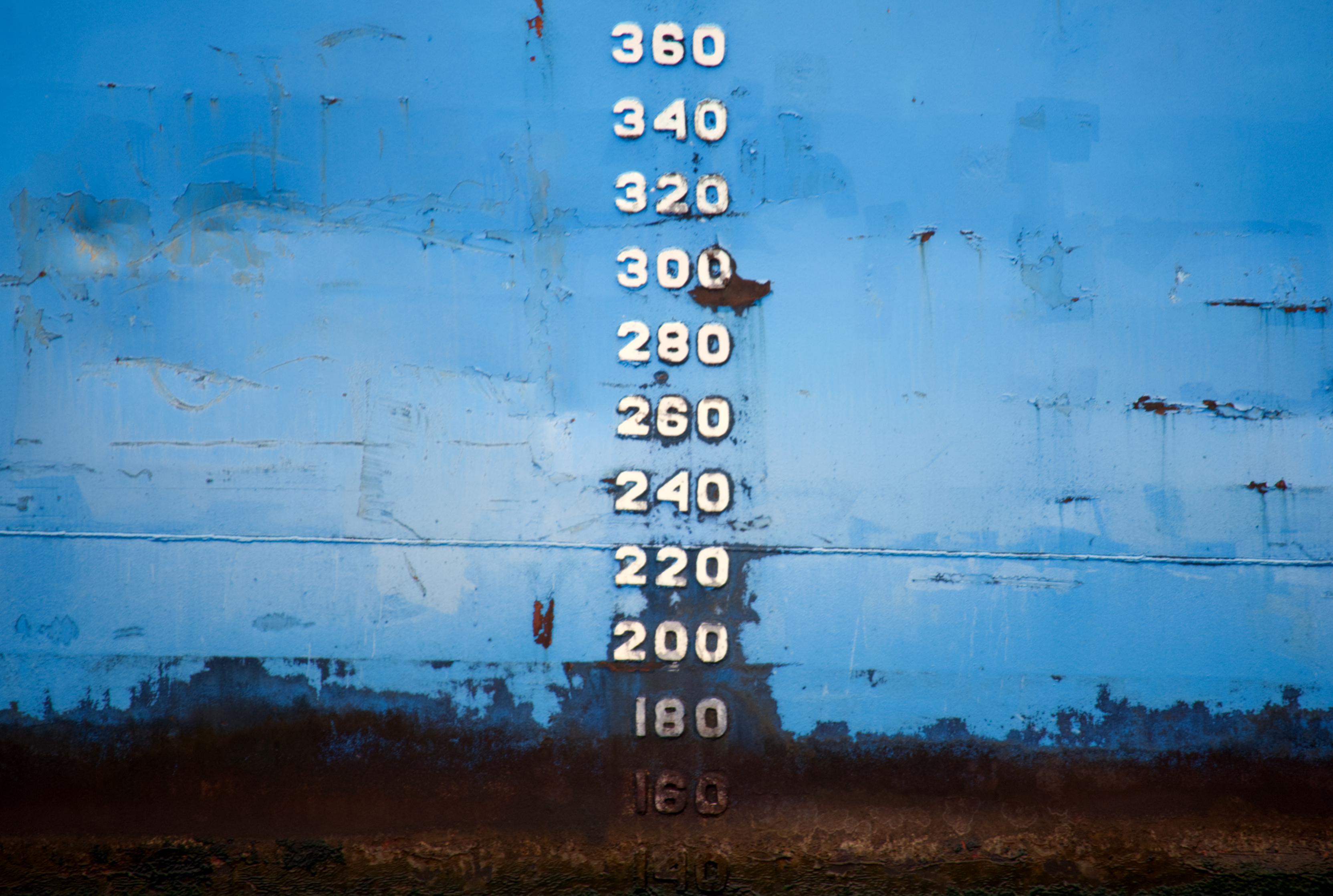 Numbers marked along the hull indicate depth and loading, showing how the vessel sits in the water under different conditions. In the Rio Negro, clearer water and lower sediment allow these measurements to be read more easily, providing a direct reference between water level and vessel displacement. On this boat, heavy use and rust is seen on the bottom numbers, suggesting how deep the vessel always sits, versus where it sometimes reaches.