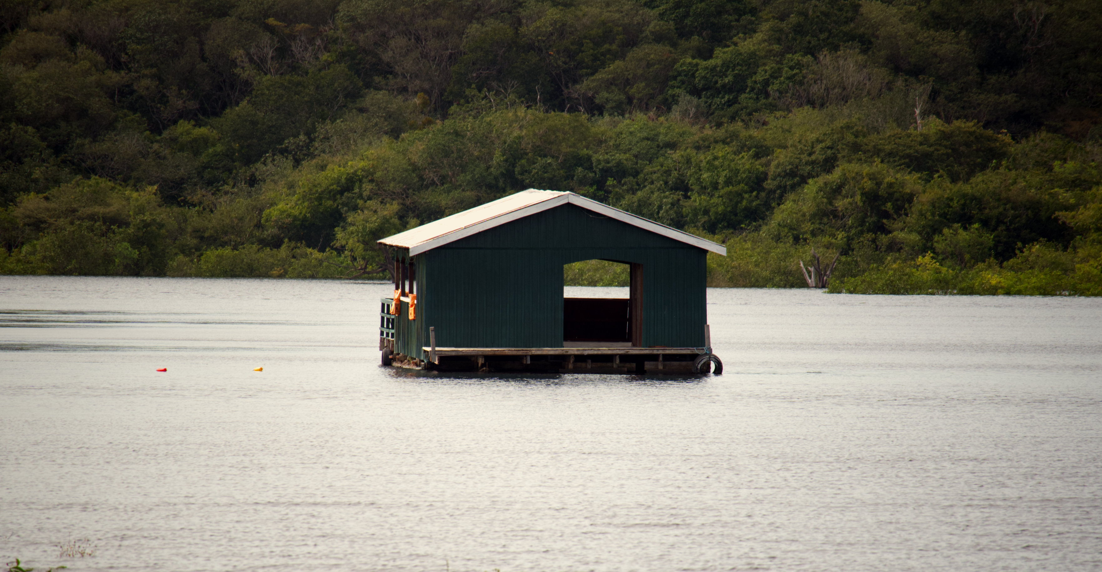 A structure sits directly atop the river, positioned to maintain access across changing water levels. Construction accounts for seasonal rise and fall, allowing continued use as the shoreline shifts.