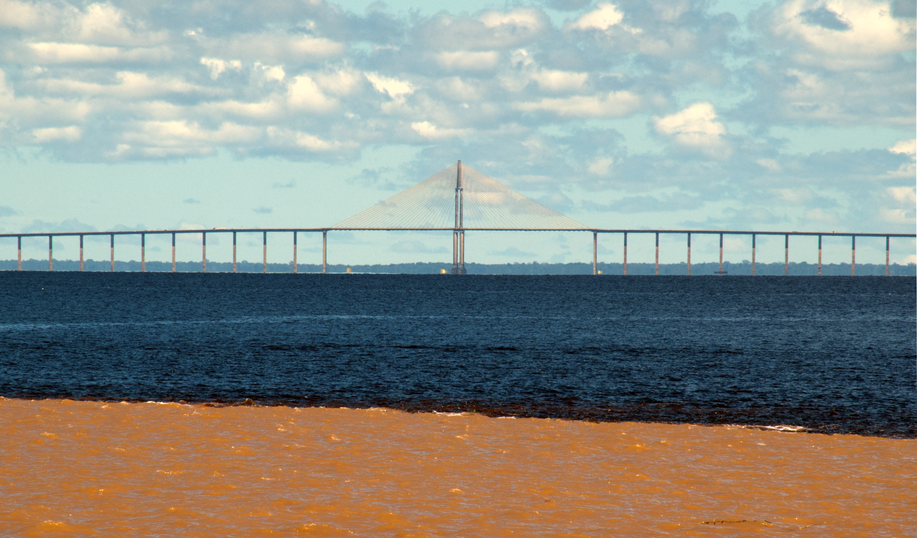 The Rio Negro Bridge links Manaus to Iranduba across one of the world's great blackwater rivers, and is often described as a "bridge to nowhere." In a region where movement has been river-based for centuries, a fixed road crossing sits somewhat at odds with the existing logic of transport. Studies following its 2011 opening documented measurable increases in deforestation as road access expanded inland. Infrastructure of this scale tends to change the places it connects, not just connect them.